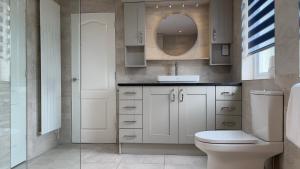 a bathroom with a toilet and a sink and a mirror at Loch Ness Cottages in Brackla +66 photos