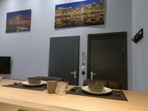a table with two cups and plates on top of it at Stijlvolle Designstudio in Almere