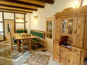 a dining room with a table and a wooden cabinet at Der Eulenblick - Seminarhaus, Ferienhaus, Gästehaus, Reitstation, Am Waldrand in Tewswoos