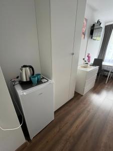 a kitchen with a refrigerator and a table in a room at Przystanek Zator in Zator