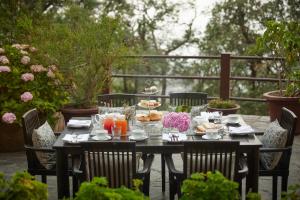 a black table with food and drinks on it at May Cottage By Rokeby Villas in Mussoorie