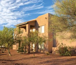 a brick house with trees in front of it at Wyndham Rancho Vistoso in Oro Valley
