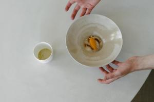a person holding a bowl and a cup of coffee at Les Hauts de Sancerre in Sancerre