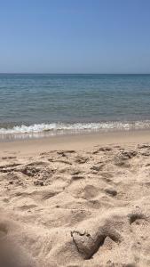 a heart drawn in the sand on the beach at Villetta farfalle in Sarroch