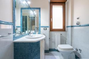 a bathroom with a sink and a toilet and a shower at P012 Apartment in Cagliari +17 photos