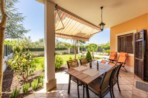 a patio with a wooden table and chairs at Olea Magica Apartments in Rovinj