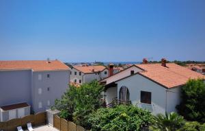 a view of a city with houses and a fence at Lovely Apartment In Novigrad in Karpinjan