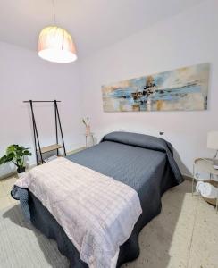 a bedroom with a bed and a painting on the wall at Casa en el Camino de Santiago en Barro in Barro +17 photos