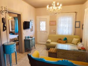 a living room with a couch and a table at Nautica Blue - House in Ofrínion