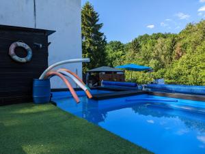 a pool with a water slide in a yard at Le Studio G in Betting-lès-Saint-Avold