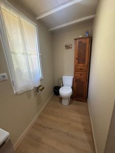 a small bathroom with a toilet and a window at Casa Gracia in Granda +8 photos