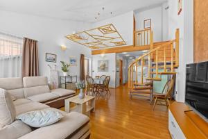 a living room with a couch and a staircase at Olea Magica Apartments in Rovinj