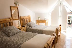 Postel nebo postele na pokoji v ubytování Hostal Sango Sierra de las Nieves