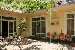 a patio of a house with chairs and a table at Apart Hotel Clumba in Odesa