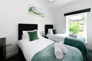 Ένα ή περισσότερα κρεβάτια σε δωμάτιο στο Comfy 3-Bed Home in Llansamlet