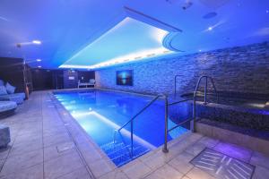a large swimming pool with a blue lighting at Harbour Hotel & Spa Christchurch in Christchurch