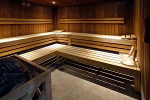 an empty sauna with wooden seats in a room at Harbour Hotel & Spa Christchurch in Christchurch