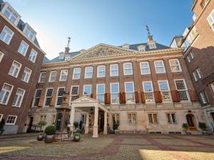 a large brick building with a courtyard at Sofitel Legend The Grand Amsterdam in Amsterdam