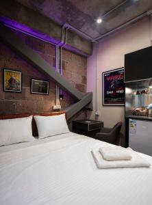 a bedroom with a white bed and a brick wall at AREA Hotel Yerevan in Yerevan +50 photos