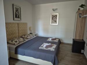 a bedroom with a bed with a blue comforter at Rooms Lami in Dubrovnik