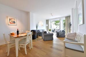 eine Küche und ein Wohnzimmer mit Tisch und Stühlen in der Unterkunft Ferienwohnung Silbermöwe in Sassnitz + 16 Fotos