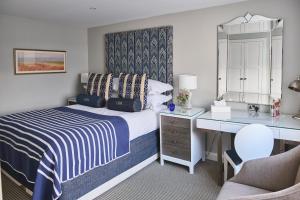 a hotel room with a bed and a desk at Harbour Hotel & Spa Christchurch in Christchurch