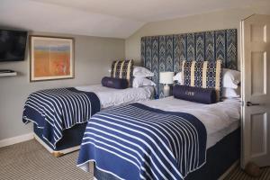 a hotel room with two beds and a tv at Harbour Hotel & Spa Christchurch in Christchurch