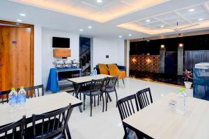 a restaurant with tables and chairs and a bar at Collection O Sector 143B Noida in Noida +21 photos