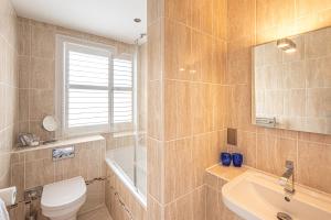 a bathroom with a toilet and a sink at Harbour Hotel & Spa Christchurch in Christchurch