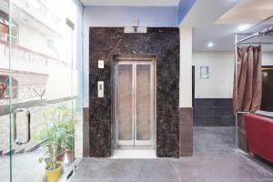 a bathroom with a shower and a glass door at Collection O Maithli Marg Sector 55 Noida in Indirapuram