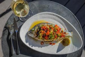 a plate of food with a fish on a table at Harbour Hotel & Spa Christchurch in Christchurch