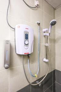 a shower in a bathroom with a phone on the wall at Cool Climate Comfort Cameron Highlands Holiday Clover Home 4-27 in Brinchang +96 photos