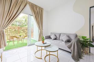 a living room with a couch and a table at Cool Climate Comfort Cameron Highlands Holiday Clover Home 4-27 in Brinchang