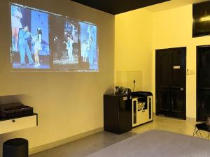 a room with a large projection screen on the wall at Four P Home - Binh Thanh in Ho Chi Minh City