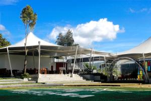 a white tent in front of a building at Trizara Resorts - Glam Camping in Lembang
