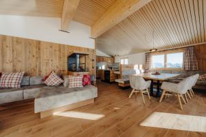 a living room with a couch and a table at Sonna Hüsli Lodge in Tschagguns