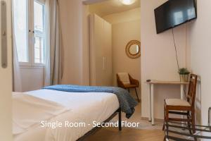 A bed or beds in a room at Affittacamere Zanobi 45