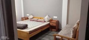 a bedroom with a wooden bed with pillows on it at Arara Ans Homestay in Cherrapunji