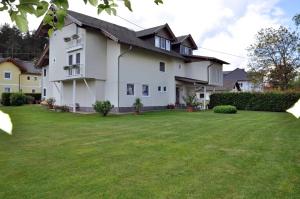 a large white house with a large yard at Appartements Irene in Sankt Kanzian