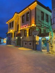 a building with a neon sign on the side of it at Odunpazarı Paşa Konak Hotel in Eskisehir