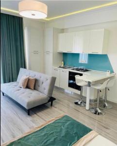 a living room with a couch and a table in a kitchen at White Tower Apart Hotel in Mamaia