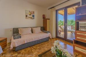 a bedroom with a bed and a sliding glass door at Gato in Novalja