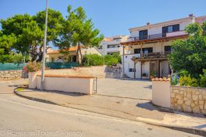 an empty street in front of a house at Gato in Novalja