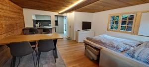 a bedroom with a bed and a table and chairs at Chalet Bernadette in Mörel