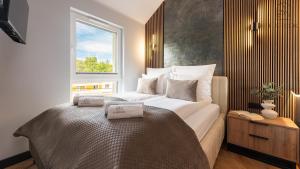Postel nebo postele na pokoji v ubytování Jantar Resort Flatbook - Wynajem Apartamentów nad Morzem