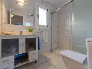 a white bathroom with a sink and a shower at POSIDONIA - Espectaculares vistas al mar in L'Ampolla +23 photos