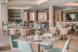 a dining room with tables and chairs at Amadria Park Grand Hotel 4 Opatijska Cvijeta in Opatija