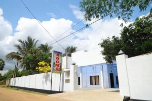 a white building with a sign in front of it at The Dream Rooms & Hottels in Puttalam