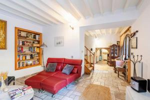 a living room with a red couch in a room at Casa de La Flora by Rhodes4vacation in Rhodes Town