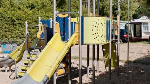 a playground with a slide in a park at Domki Nad Morzem IDPB in Gąski